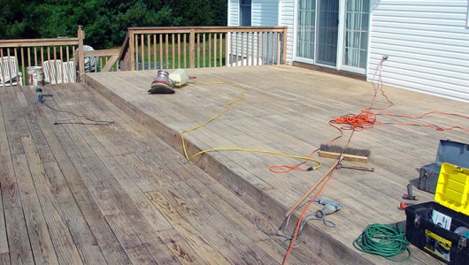 The bulk of the old sealer has been stripped off. We are now buffing and sanding the deck.