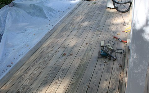 The pressure treated wood next to the koi pond did not have paint on it. It was cleaned, sanded and buffed.