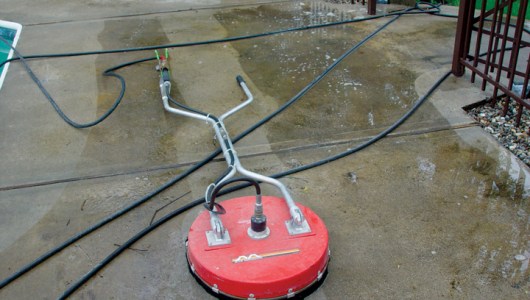 Concrete cleaning with a hot water surface cleaner.