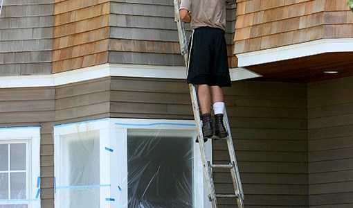 Oiling western red cedar with a dove grey oil.