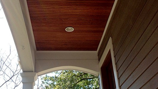 The cedar porch ceiling beadboard and overhangs were oiled in a light brown penetrating oil to complement the dove gray.