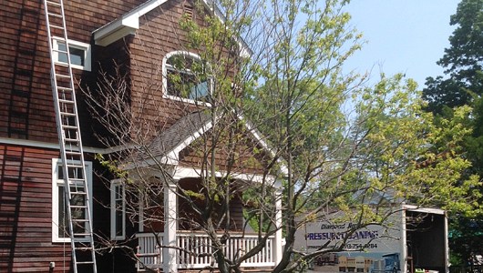 This side of cedar house was just treated. The next step would be to brighten the wood.